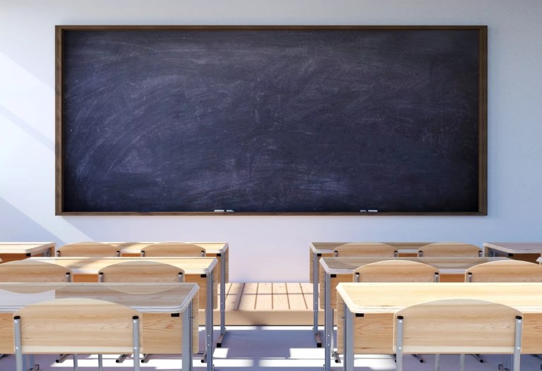 Empty classroom interior with student desk and chairs