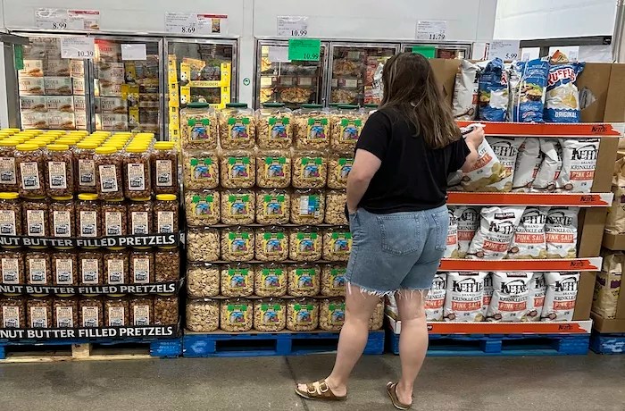 Consumer sentiment. A shopper considers a purchase in a Costco warehouse