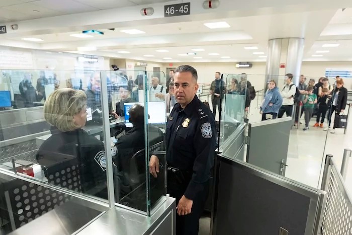 Customs and Border Protection's Port of Washington Dulles Executive Director of Admissibility and Passenger Program Ray Provencio, observes the procedures in place in the port of entry at Washington Dulles International Airport in Chantilly, Virginia, Monday, April 1, 2024.