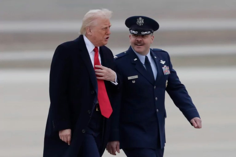 President Donald Trump speaks with Col. Paul Pawluk, Vice Commander of the 89th Airlift Wing, as he walks from Marine One before boarding Air Force One, Friday, March 14, 2025, at Joint Base Andrews, Md. (AP Photo/Luis M. Alvarez)