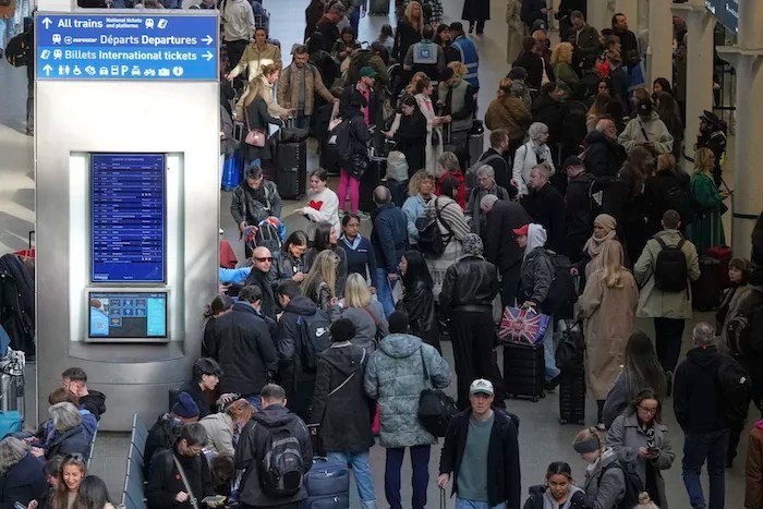Passengers queue and wait near departures for Eurostar services at St Pancras International station in London, Friday March 7, 2025, after Eurostar trains to the capital were halted following the discovery of an unexploded Second World War bomb near the tracks in Paris.