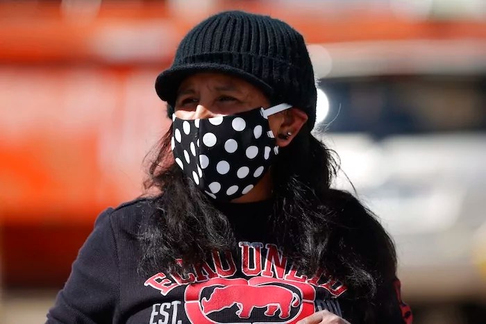 Jeanette Vizguerra wears a face mask during a car protest calling for the release of detainees at the GEO Immigration Detention Center because of the dangers posed by the new coronavirus Friday, April 17, 2020, in Denver. The new coronavirus causes mild or moderate symptoms for most people, but for some, especially older adults and people with existing health problems, it can cause more severe illness or death. (AP Photo/David Zalubowski)
