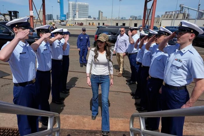 Homeland Security Secretary Kristi Noem boards the U.S. Coast Guard cutter Elm before participating in an assault boat demonstration with the Maritime Security Response Team, Sunday, March 16, 2025, in San Diego.
