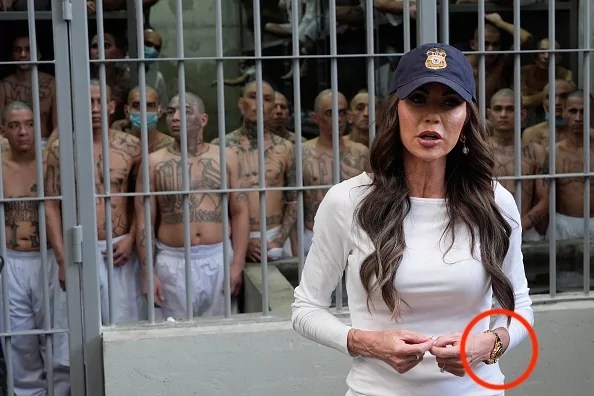Secretary of Homeland Security Kristi Noem speaks during a tour of the Terrorist Confinement Center as prisoners stand, looking out from a cell, in Tecoluca, El Salvador, March 26, 2025.