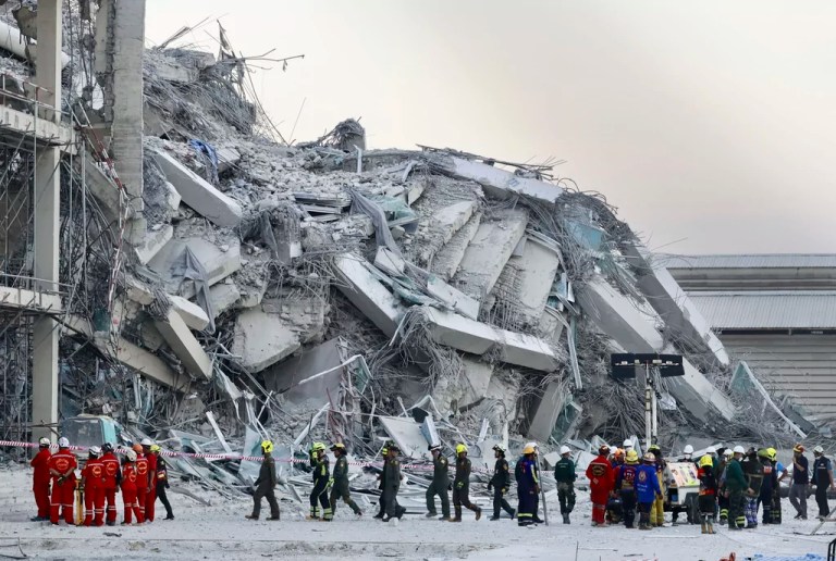 Rescuers work at the site a high-rise building under construction that collapsed after a 7.7 magnitude earthquake in Bangkok, Thailand, Friday, March 28, 2025.