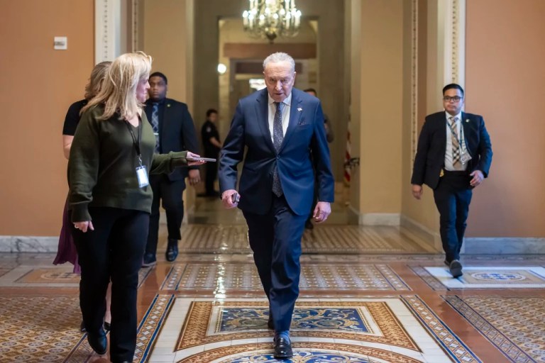Senate Minority Leader Chuck Schumer (D-NY) speaks to a reporter near the Senate chamber as the Senate works to avert a partial government shutdown ahead of the midnight deadline at the Capitol in Washington, Friday, March 14, 2025.