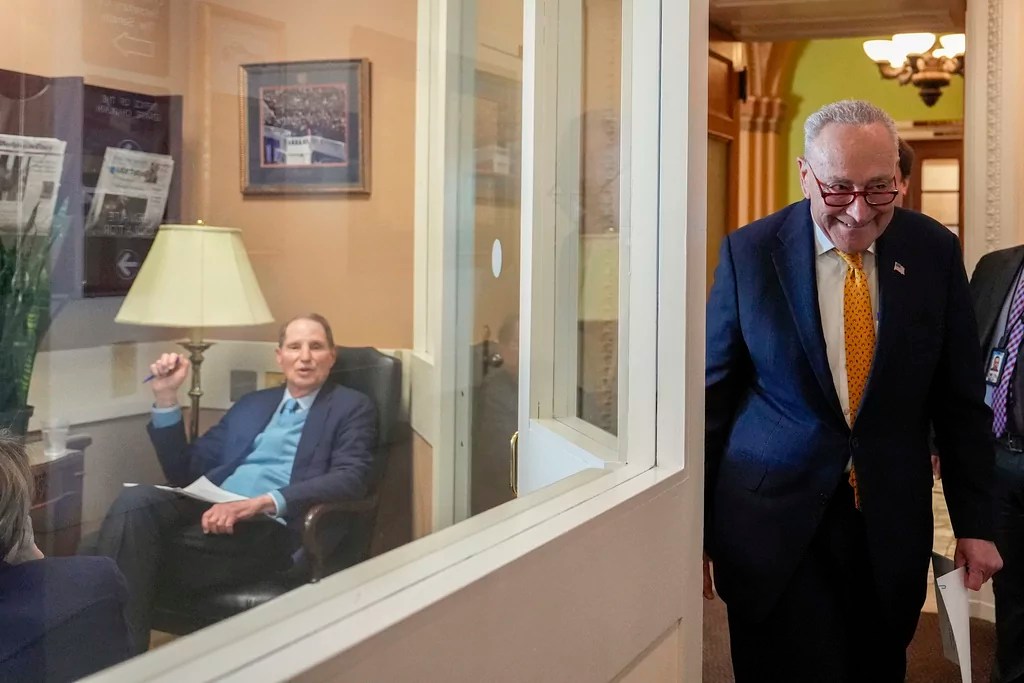 Sen. Ron Wyden (D-OR), left, looks on as Senate Minority Leader Chuck Schumer (D-NY), right, walks to speak at a news conference on Social Security benefits, Monday, March 3, 2025, at the Capitol in Washington.