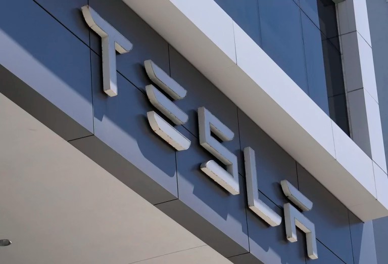 The Tesla logo is displayed at a Tesla dealership Thursday, Mar. 13, 2025, in Miami.