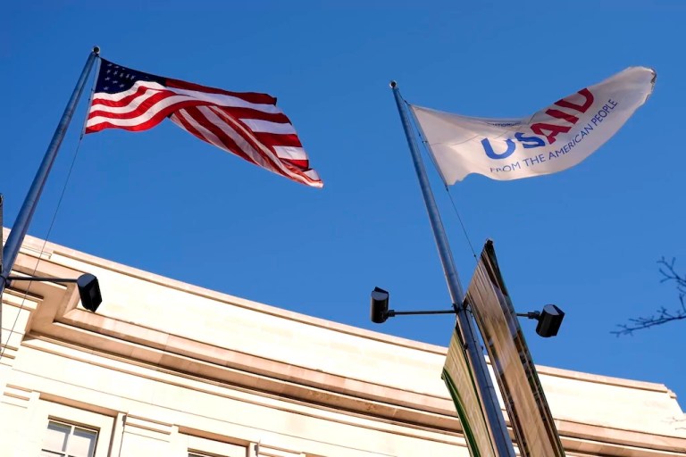 The U.S. Agency for International Development, or USAID, flag and the American flag flying in front of a building in Washington, D.C.