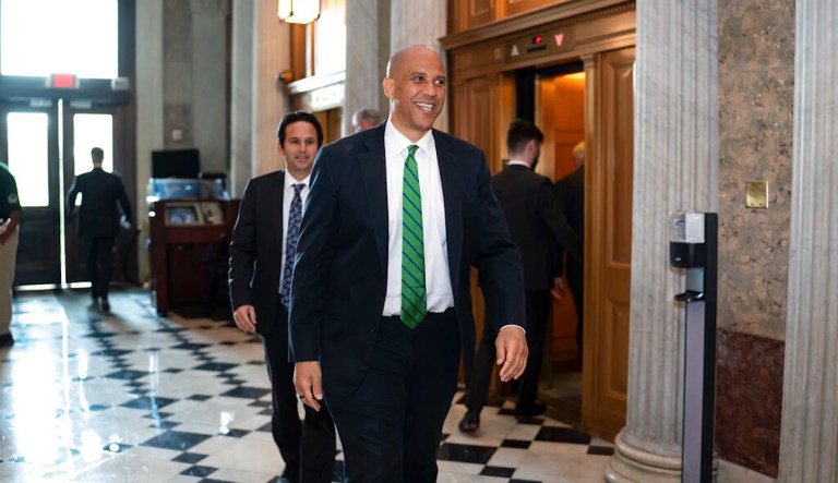 Sen. Cory Booker, D-N.J., followed by Sen. Brian Schatz, D-Hawaii, arrives before a procedural vote on the Women's Health Protection Act to codify the landmark 1973 Roe v. Wade decision that legalized abortion nationwide, at the Capitol in Washington, Wednesday, May 11, 2022. President Joe Biden called on Congress to pass legislation that would guarantee the constitutional right to abortion services after the disclosure of a draft Supreme Court opinion that would overturn Roe v. Wade. (AP Photo/J. Scott Applewhite)