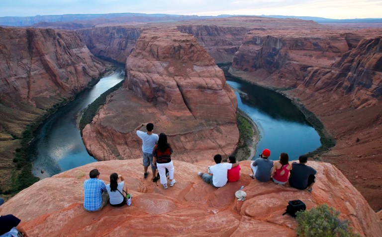 Visitors view the dramatic bend in the Colorado River at the popular Horseshoe Bend in Glen Canyon National Recreation Area, in Page, Arizona, on Sept. 9, 2011.