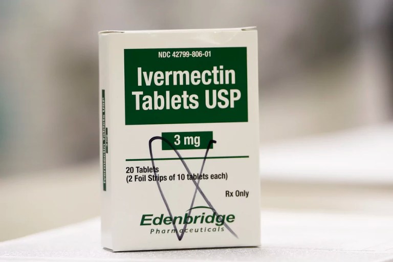 A box of ivermectin is shown in a pharmacy as pharmacists work in the background, Thursday, Sept. 9, 2021, in Georgia.