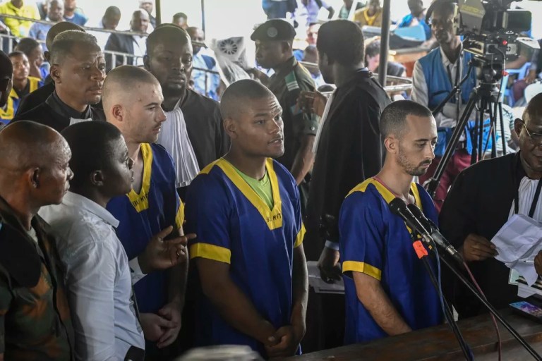 Tyler Thompson Jr., Marcel Malanga and Benjamin Reuben Zalman-Polun, all American citizens, face the court in Kinshasa, Congo, with 52 other defendants, June 7, 2024, accused of a role in the attempted coup in Congo led by little-known opposition figure Christian Malanga in which six people were killed.