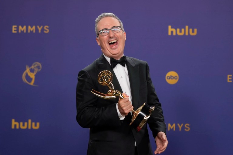 John Oliver poses in the press room with the award for outstanding scripted variety series for 