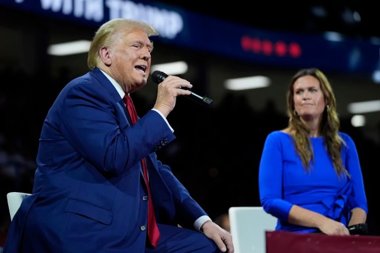 President Donald Trump, left, on stage with Gov. Sarah Huckabee Sanders (R-AR), right, during a town hall event at the Dort Financial Center, Tuesday, Sept. 17, 2024, in Flint, Michigan.