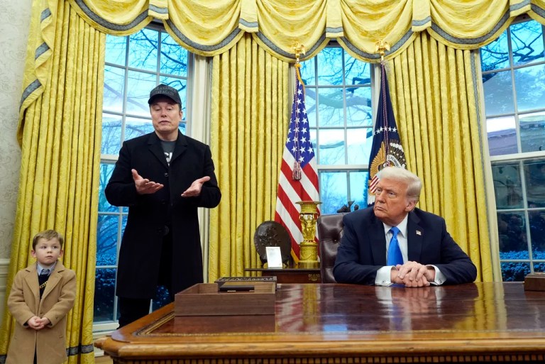 President Donald Trump listens as Elon Musk, joined by his son X Æ A-Xii, speaks in the Oval Office at the White House, Tuesday, Feb. 11, 2025, in Washington. (AP Photo/Alex Brandon)