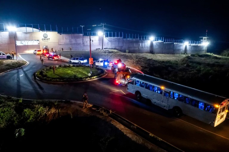 In this photo provided by El Salvador's presidential press office, a bus carrying deportees from the United States arrives to the Terrorism Confinement Center in Tecoluca, Monday, March 31, 2025.