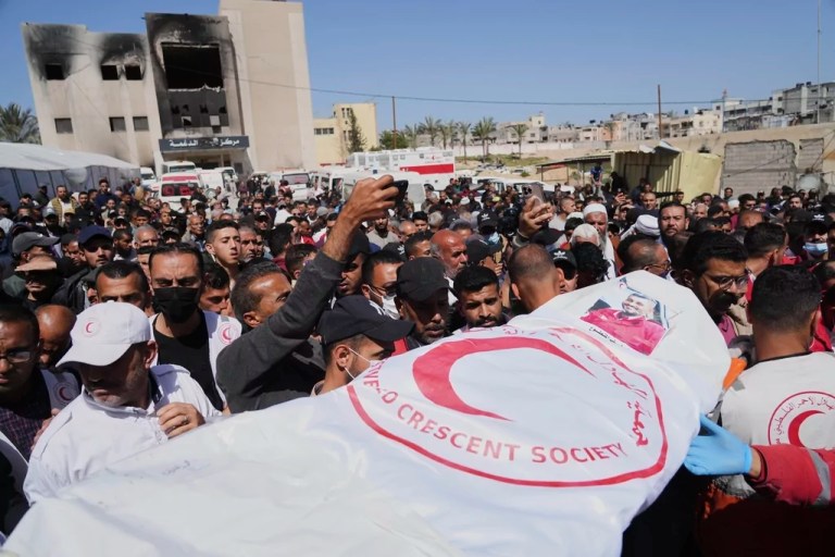 Mourners carry the bodies of 8 Red Crescent emergency responders, recovered in Rafah a week after an Israeli attack, as they are transported for burial from a hospital in Deir al-Balah, Gaza Strip, on Monday, March 31, 2025.