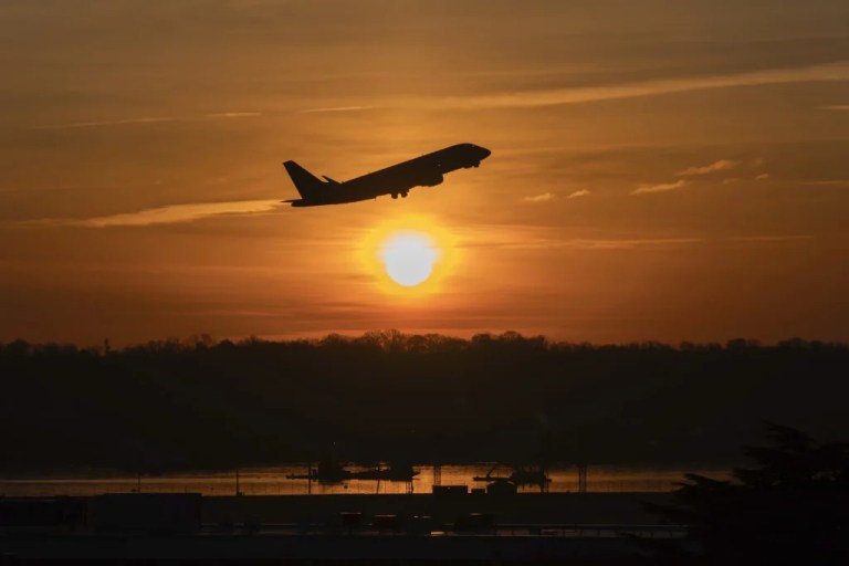 An airplane lifts off from Ronald Reagan Washington National Airport as the sun rises Monday, Feb. 3, 2025, in Arlington, Va.