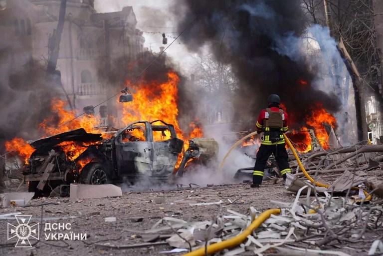 In this photo provided by the Ukrainian Emergency Service, firefighters put out the fire following Russia's missile attack that killed at least 20 civilians in Sumy, Ukraine