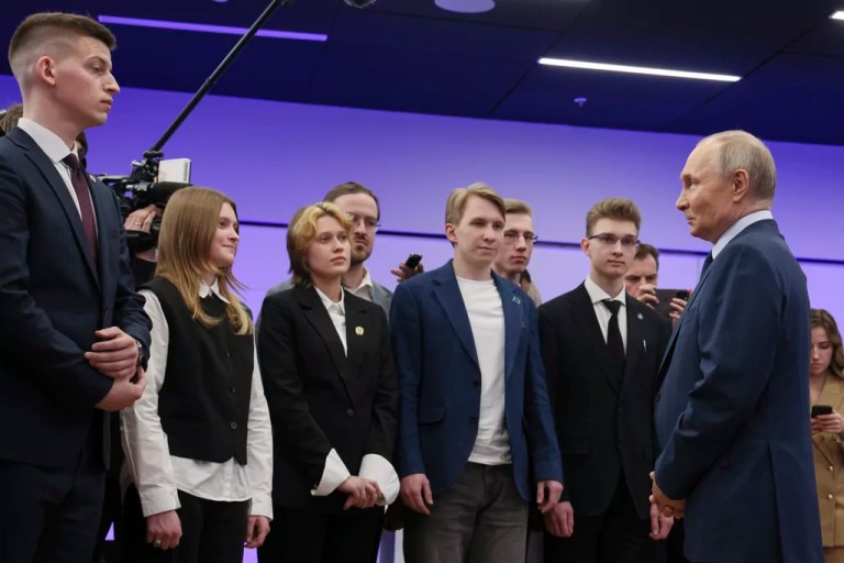 Russian President Vladimir Putin, right, speaks to students while visiting The Bauman Moscow State Technical University in Russia, Wednesday, April 16, 2025.