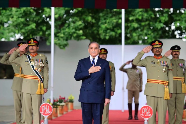 In this photo released by the Prime Minister Office, Pakistan's Prime Minister Shehbaz Sharif, center, and Army Chief General Asim Munir, left, attend a passing out ceremony of army officers at the Pakistan Military Academy Kakul, in Abbottabad, Pakistan