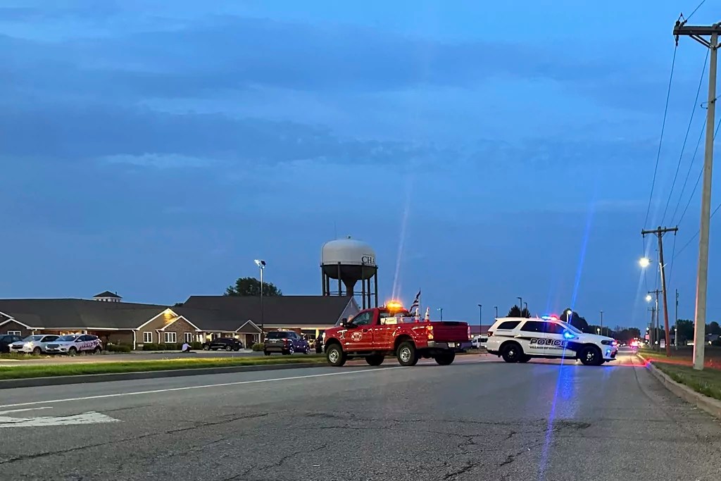 Emergency vehicles block a road leading to a building where a car smashed through during an after-school program, killing several people and injuring others