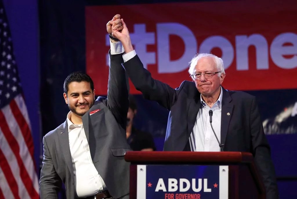Michigan Democratic gubernatorial candidate Dr. Abdul El-Sayed, left, and Sen. Bernie Sanders raise their arms after addressing supporters during a rally for El-Sayed, Sunday, Aug. 5, 2018, in Detroit. 
