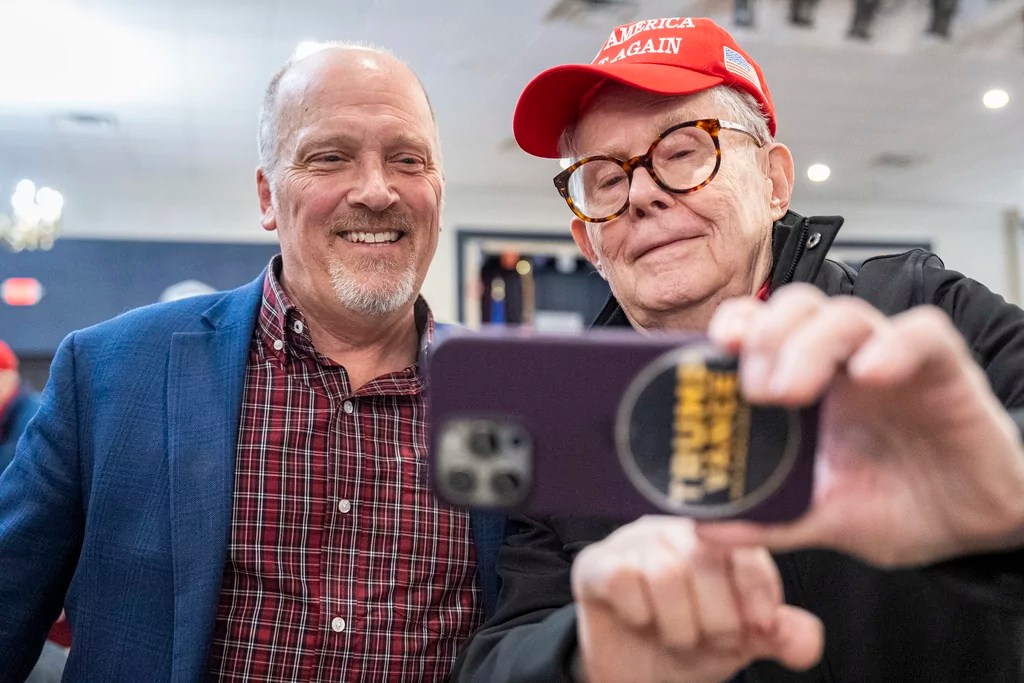 Wisconsin Supreme Court candidate Brad Schimel takes a photo with a supporter at a rally Saturday, March 29, 2025 on a campaign stop at the American Serb Memorial Hall in Milwaukee.