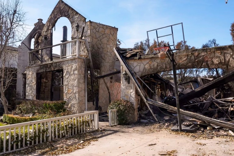 FILE - A basketball is stuck in the net outside of a residence destroyed by the Palisades Fire in the Pacific Palisades neighborhood of Los Angeles, Friday, Jan. 24, 2025.