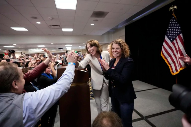 Wisconsin Supreme Court candidate Susan Crawford, center, celebrates with a supporter during her election night party after winning the election Tuesday, April 1, 2025, in Madison, Wis. (AP Photo/Kayla Wolf)