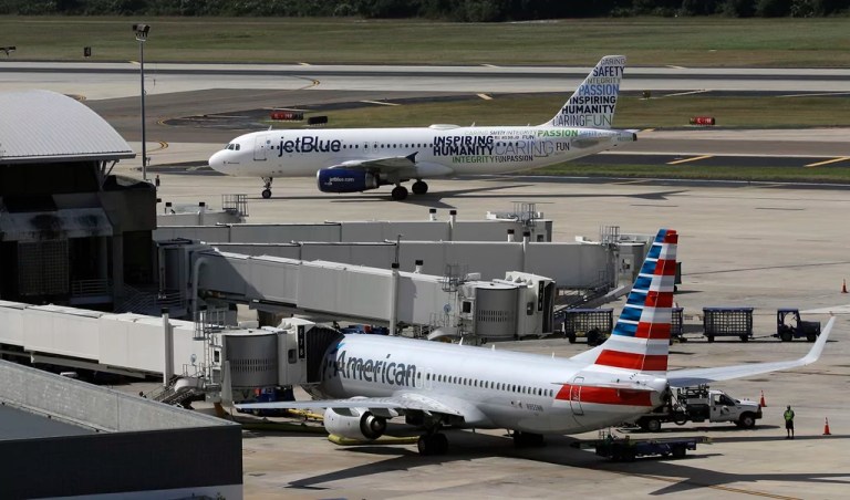 A JetBlue Airbus A320 taxis to a gate after landing, Oct. 26, 2016, as an American Airlines jet is seen parked at its gate at Tampa International Airport in Tampa, Fla. JetBlue on Wednesday, July 5, 2023, said it won't appeal a judge's ruling against its partnership with American Airlines, effectively dropping the deal in an effort to salvage its purchase of Spirit Airlines.