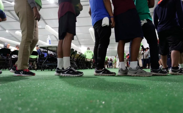 Immigrants line up in the dining hall at a U.S. government holding center for migrant children, July 9, 2019, in Carrizo Springs, Texas.