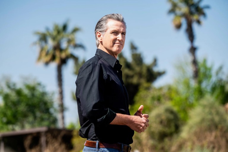 Gov. Gavin Newsom (D-CA) listens during a press conference about President Donald Trump's tariffs, Wednesday, April 16, 2025, at an almond farm in Ceres, California.