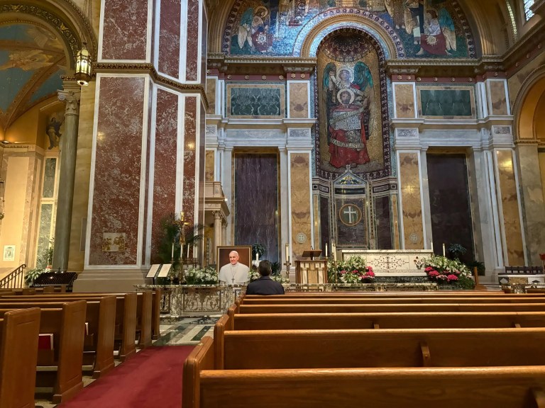 A parishioner mourns Pope Francis in the Cathedral of St. Matthew the Apostle.