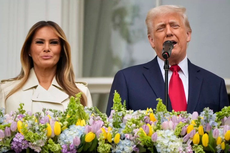 President Donald Trump and first lady Melania Trump stand on the Blue Room Balcony as they participate in the White House Easter Egg Roll on the South Lawn of the White House, Monday, April 21, 2025, in Washington.