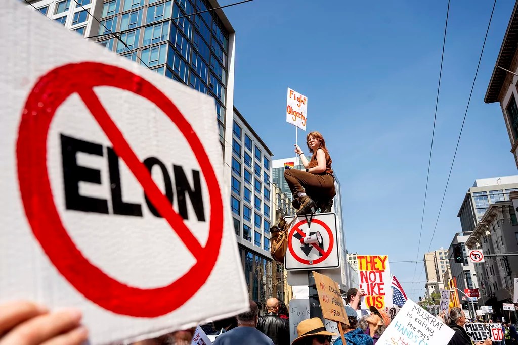 Protesters rally against Tesla CEO Elon Musk outside a Tesla store in San Francisco on Saturday, March 29, 2025. (AP Photo/Noah Berger)