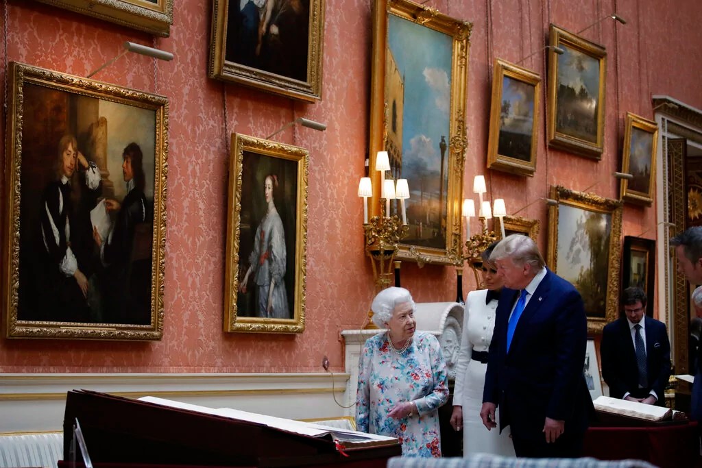 President Donald Trump, first lady Melania Trump and Queen Elizabeth II, walk in the Picture Gallery at Buckingham Palace, Monday, June 3, 2019, in London.