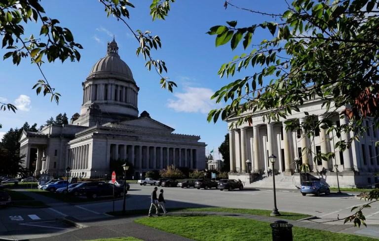 FILE - The afternoon sun illuminates the Legislative Building, left, at the Capitol in Olympia, Wash, Oct. 9, 2018. In a Tuesday, Feb. 6, 2024, vote, the Washington state Senate unanimously approved legislation that would ban police from hog-tying suspects, a restraint technique that has long drawn concern due to the risk of suffocation.