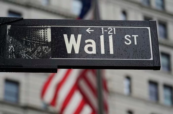A Wall St. sign is displayed near the New York Stock Exchange in New York, Monday, April 7, 2025.