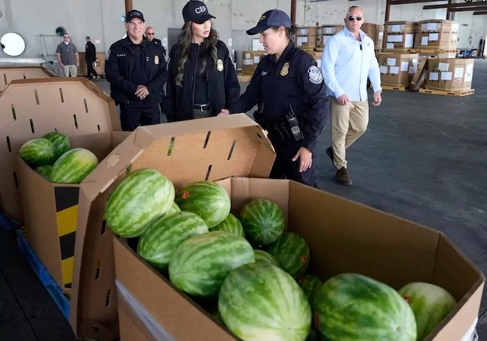 Homeland Security Secretary Kristi Noem, center, speaks with acting Port Director Laura Hermosillo as Guadalupe H. Ramirez, director of field operations for the Customs and Border Protection (CBP) Tucson field office, left, listens, as watermelons are inspected at the Mariposa Port of Entry, Saturday, March 15, 2025, in Nogales, Ariz. (AP Photo/Alex Brandon)