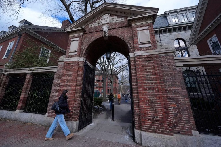 Pedestrians walk through the gates of Harvard Yard at Harvard University, Wednesday, Feb. 26, 2025, in Cambridge, Massachusetts.