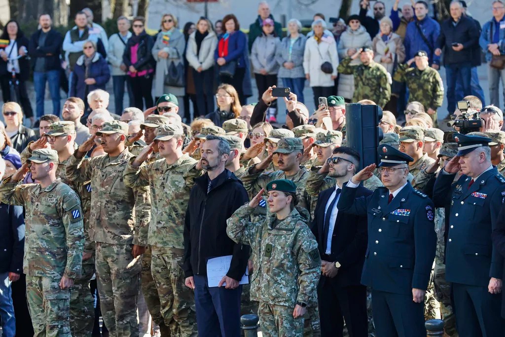 U.S. Army soldiers and Lithuanian servicemen salute as they attend a solemn farewell ceremony at Cathedral Square in Vilnius, Lithuania, Thursday, April 3, 2025 for the US soldiers who died during training exercise. (AP Photo/Mindaugas Kulbis)