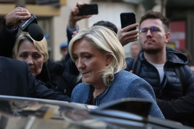 French right-wing leader Marine Le Pen leaves the National Rally headquarters after a French court convicted her of embezzlement and barred her from seeking public office for five years, Monday, March 31, 2025 in Paris.