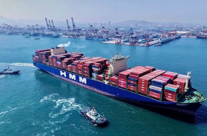 A container ship sails off from a container terminal in Qingdao in eastern China's Shandong province