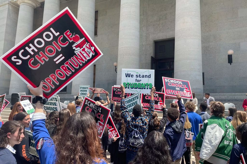 Students and parents rally at the Ohio Statehouse in support of possible changes that would increase eligibility for taxpayer-funded school vouchers to K-12 students statewide on Thursday, May 17, 2023, in Columbus, Ohio. Advocates applaud the changes as expanding school choice but opponents say such programs divert funding from public schools and violate Ohio's constitution.