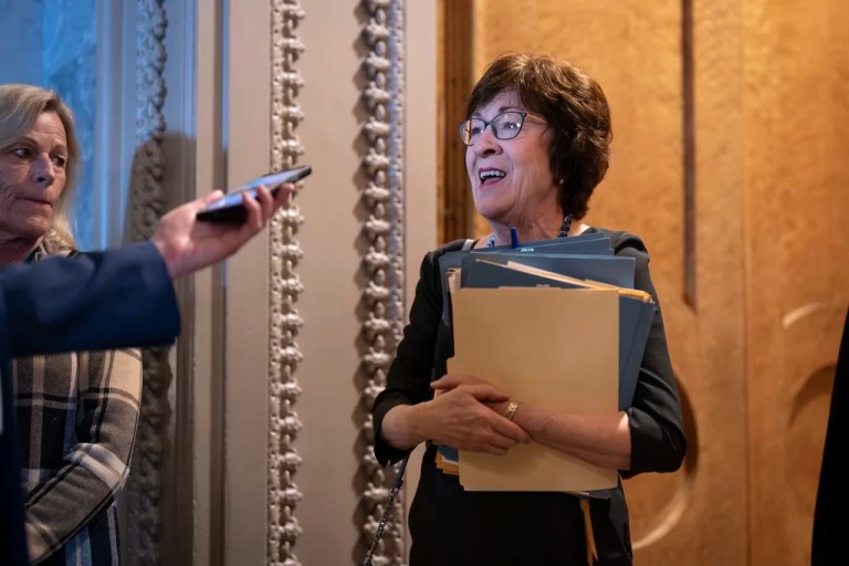 Sen. Susan Collins (R-ME), chairwoman of the Senate Appropriations Committee, pauses in the door to the chamber to answer a question from a reporter as the Senate works to avert a partial government shutdown ahead of the midnight deadline, at the Capitol in Washington, Friday, March 14, 2025.