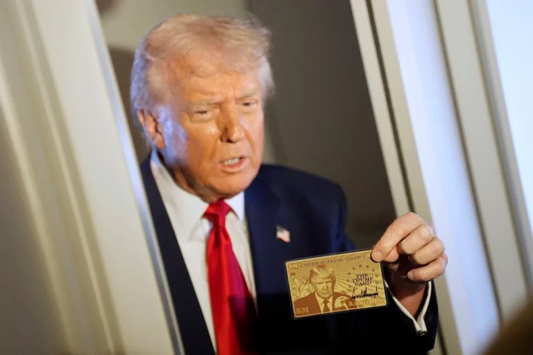 President Donald Trump holds up the $5 million gold card as he speaks to reporters while in flight on board Air Force One, en route to Miami, Thursday, April 3, 2025.
