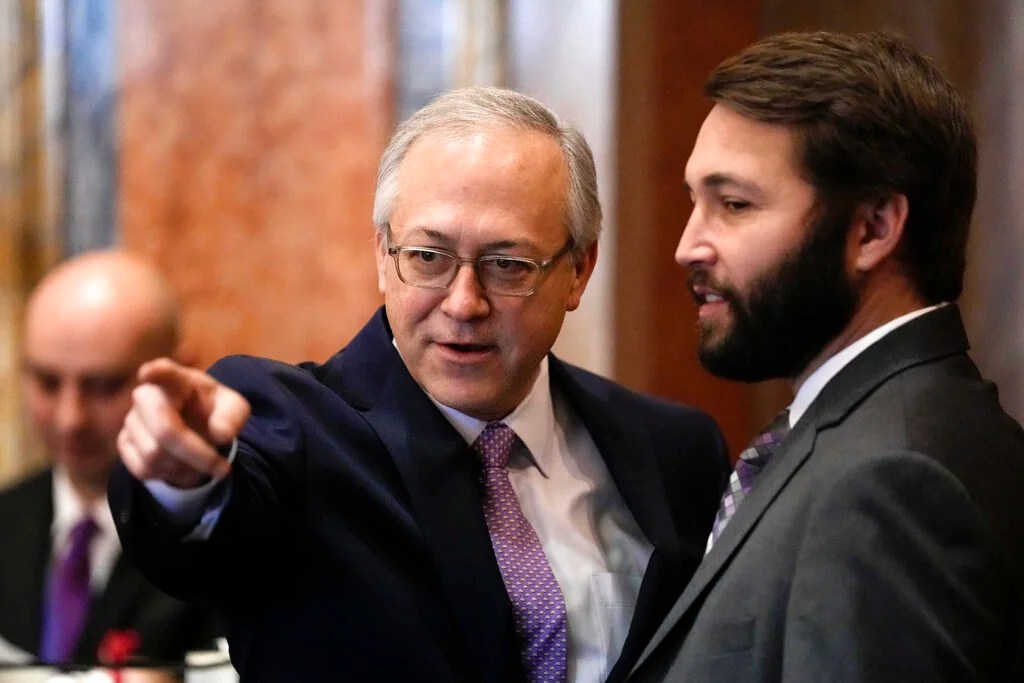 State Rep. David Young, R-Van Meter, talks with State Rep. Bobby Kaufmann, R-Wilton, right, during the opening day of the Iowa Legislature
