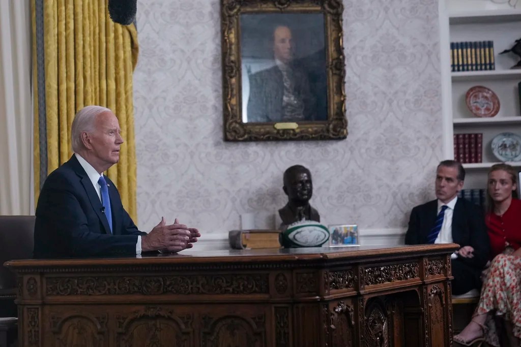 President Joe Biden addresses the nation from the Oval Office of the White House in Washington, Wednesday, July 24, 2024, on his decision not to seek reelection. Sitting on the far right are Hunter Biden and his daughter Finnegan Biden. 